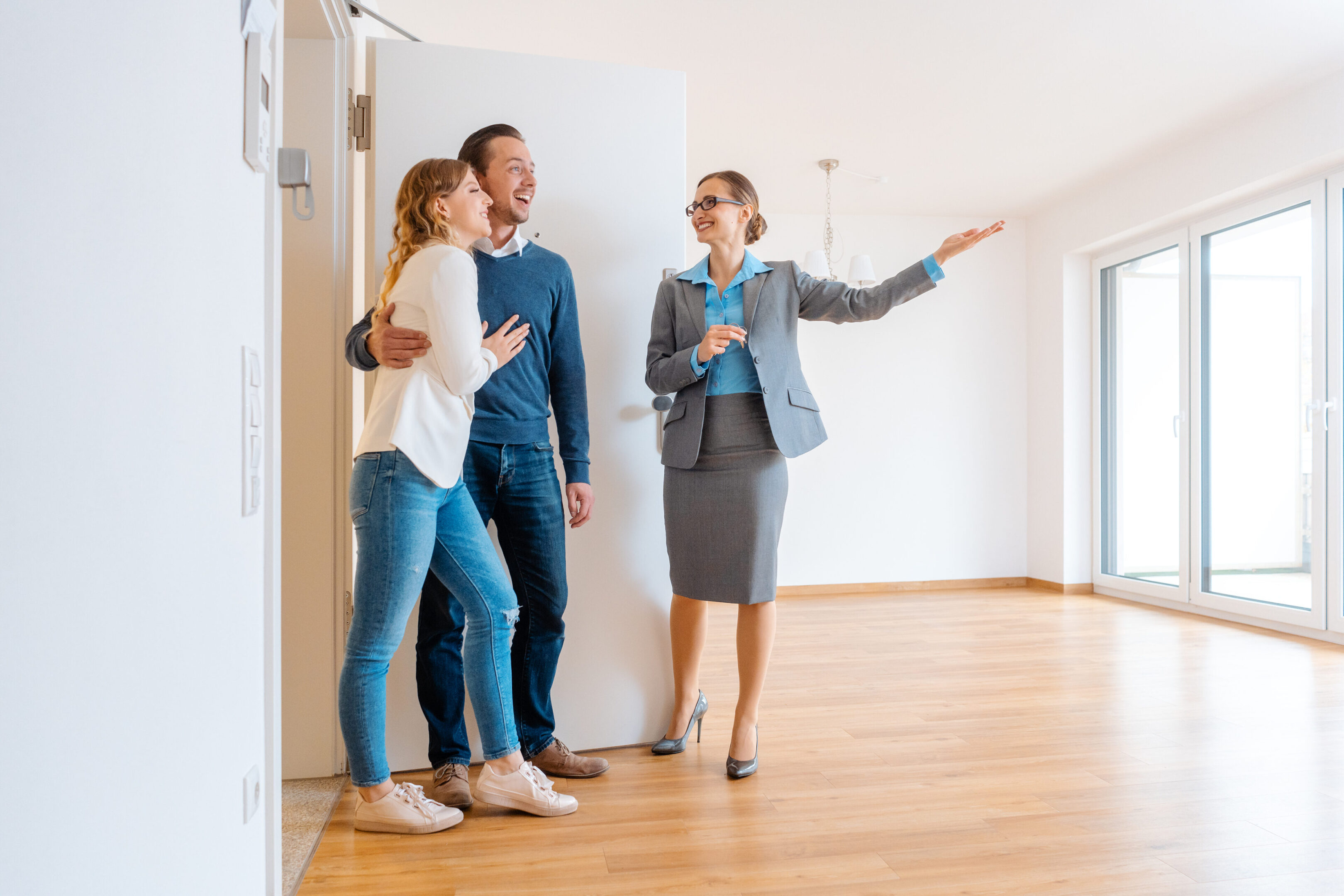 Real Estate Agent showing house to a young couple wanting to rent it